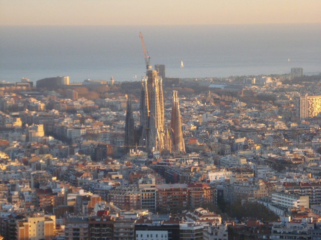 Aerial view of Barcelona with the Sagrada Família rising above the Eixample at sunset