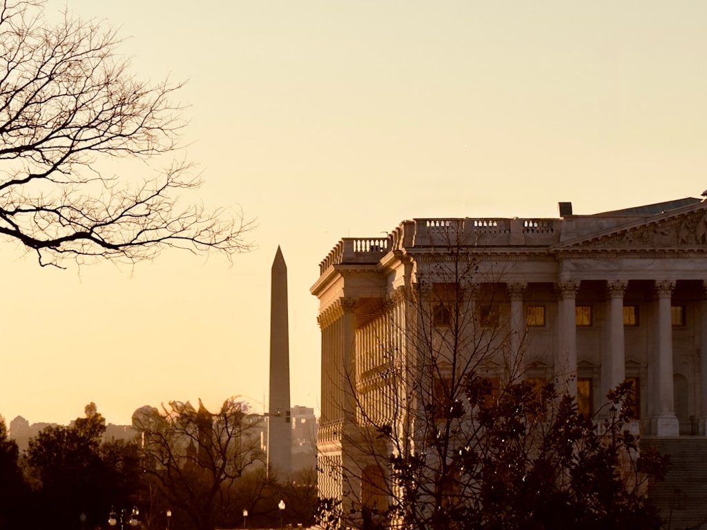 The U.S. Capitol with the Washington Monument behind it at golden hour
